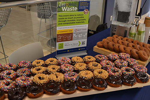 Image of zero waste event set up featuring donuts and signage.