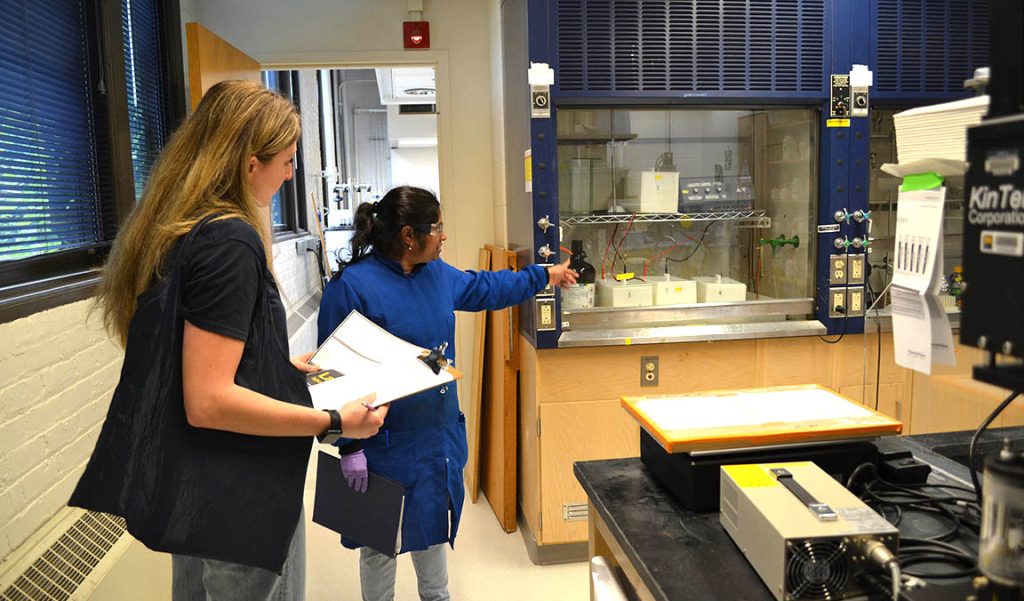 Image of OCS Staff member performing a lab visit to walk a lab occupant through the sustainable lab checklist.