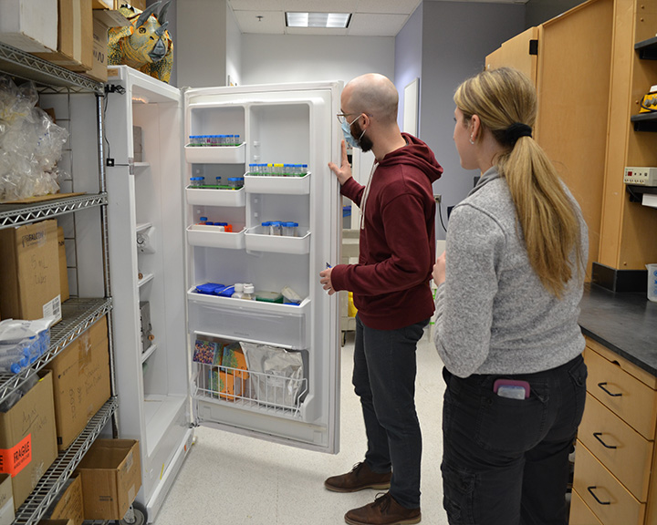 OCS Staff member and lab occupant inspect a freezer as part of the lab freezer challenge.